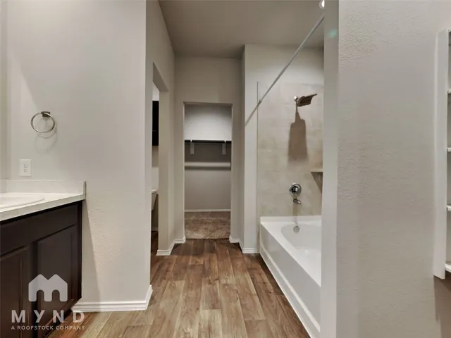 a bathroom with a bathtub and a sink