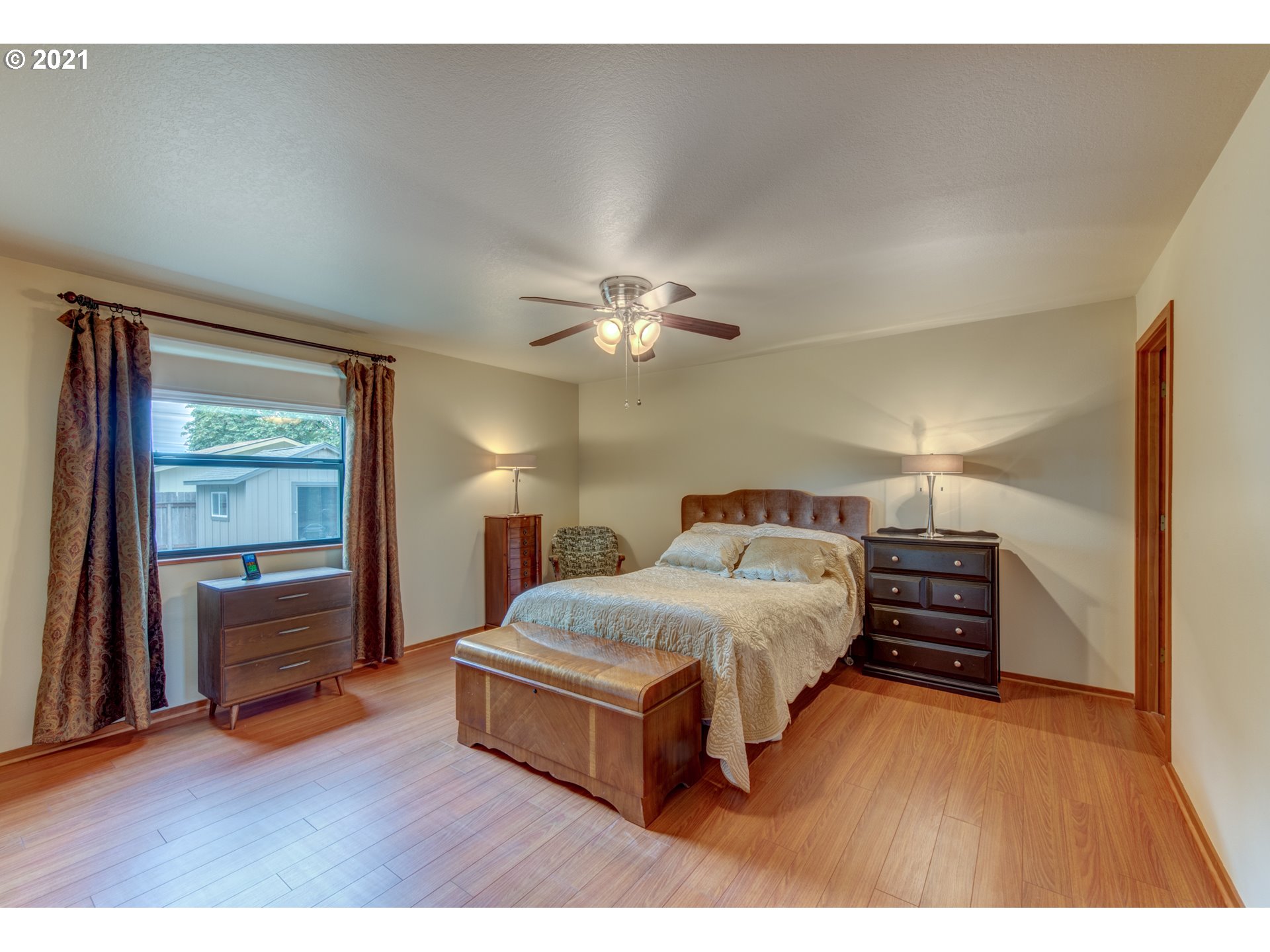 372 South 57th Place Springfield, OR 97478 - Photo 13 of 29 a bedroom with a bed and a chandelier