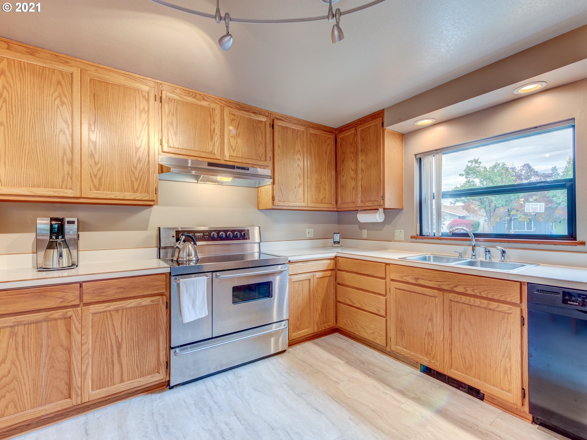 372 South 57th Place Springfield, OR 97478 - Photo 8 of 29 a kitchen with a sink cabinets wooden floor and stainless steel appliances