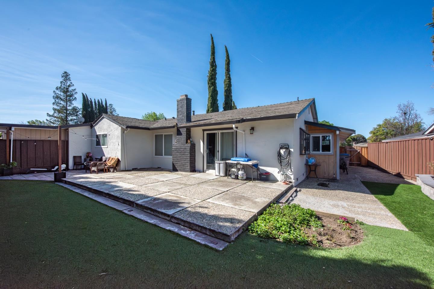 5798 Ribchester Court San Jose, CA 95123 - Photo 13 of 18 a front view of a house with a garden and chairs