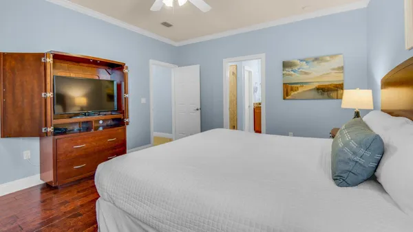 a bedroom with a bed and a flat screen tv