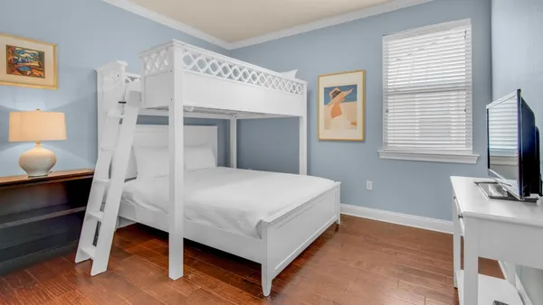 a bed room with a bed and a flat tv screen