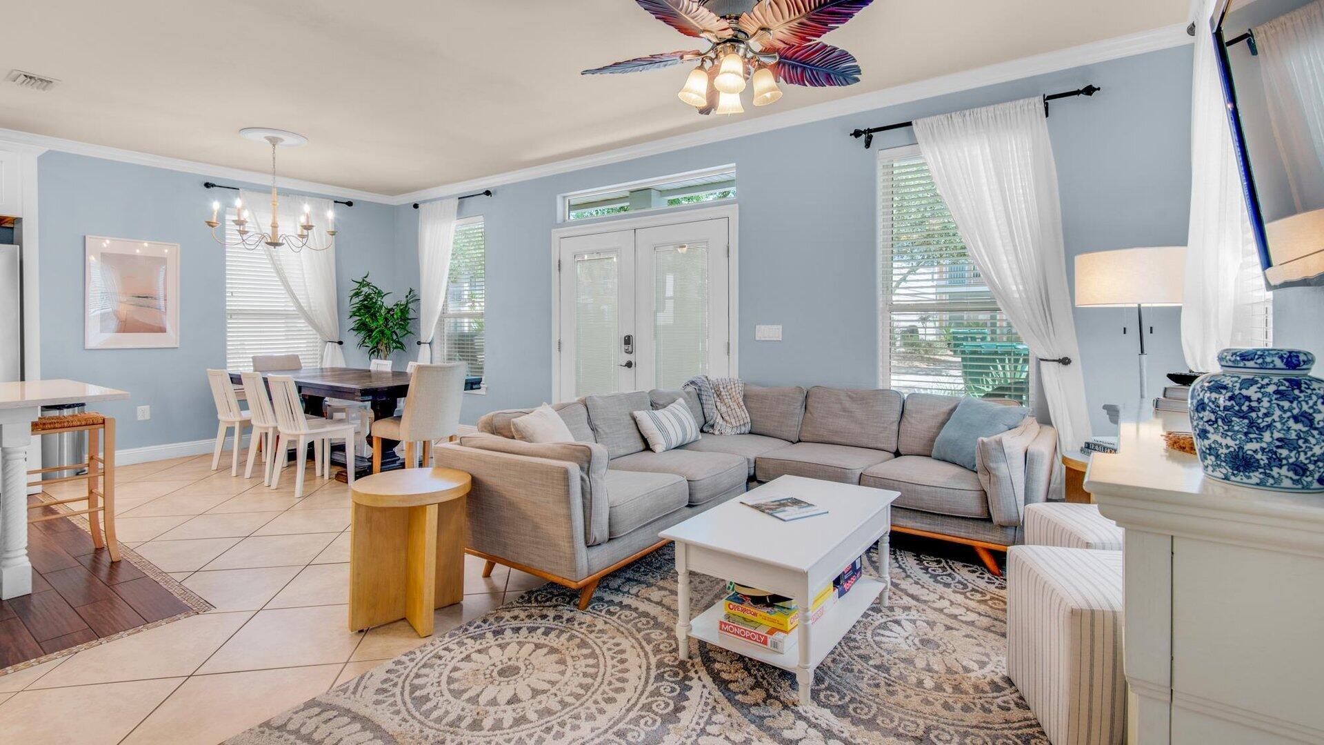 222 Kono Way Destin, FL 32541 - Photo 2 of 36 a living room with furniture a chandelier and a window
