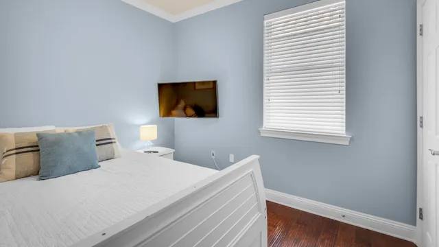 a bedroom with a bed and a flat screen tv