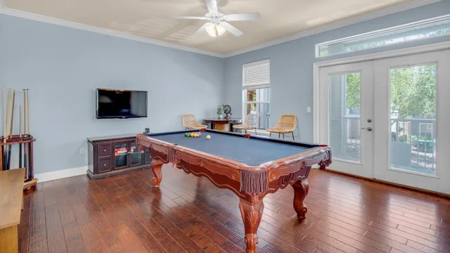 a room with wooden floors and pool table