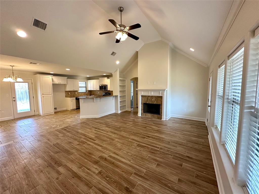 198 Bent Tree Loop Haughton, LA 71037 - Photo 2 of 32 a view of a livingroom with a fireplace a ceiling fan and wooden floor