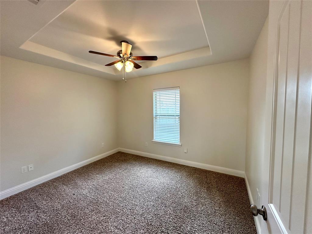 198 Bent Tree Loop Haughton, LA 71037 - Photo 21 of 32 an empty room with a ceiling fan and a window