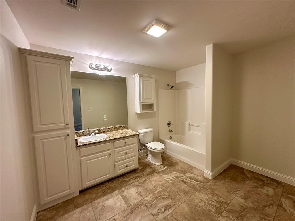 198 Bent Tree Loop Haughton, LA 71037 - Photo 25 of 32 a bathroom with a granite countertop sink a toilet and shower