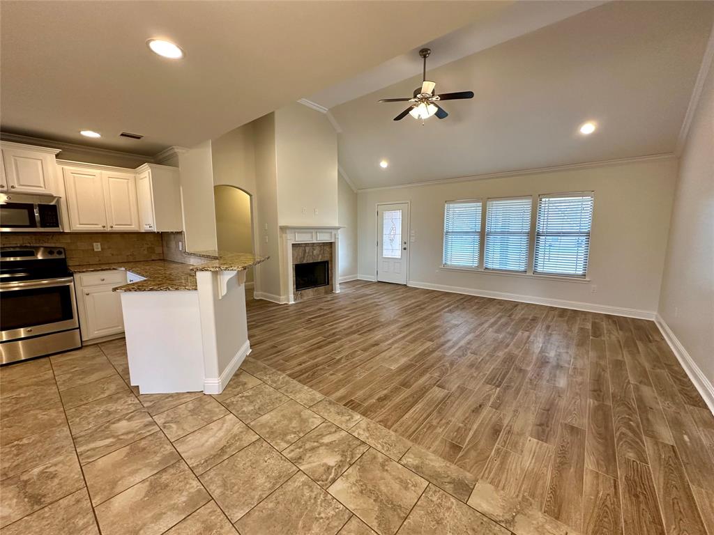 198 Bent Tree Loop Haughton, LA 71037 - Photo 3 of 32 a kitchen with granite countertop a stove a sink and a refrigerator