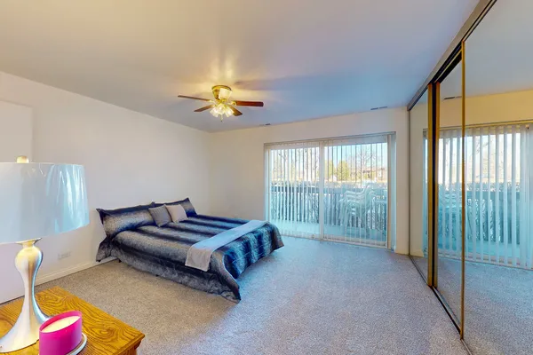 a spacious bedroom with a bed and a chandelier
