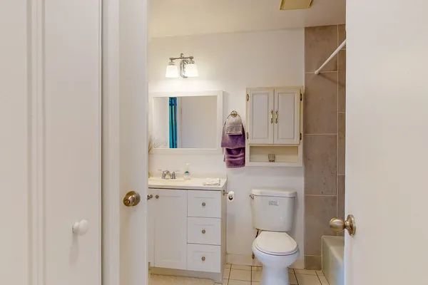 a bathroom with a toilet a sink and mirror