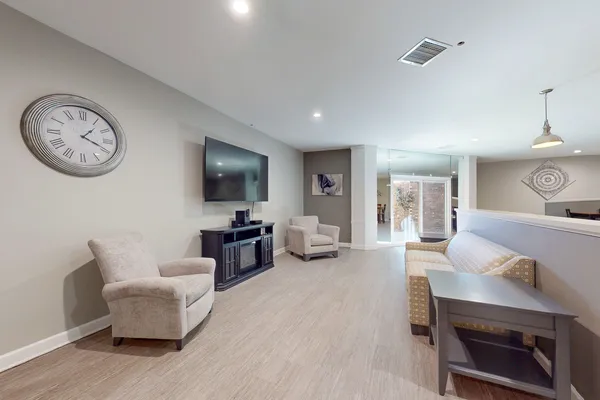 a living room with furniture and floor to ceiling windows