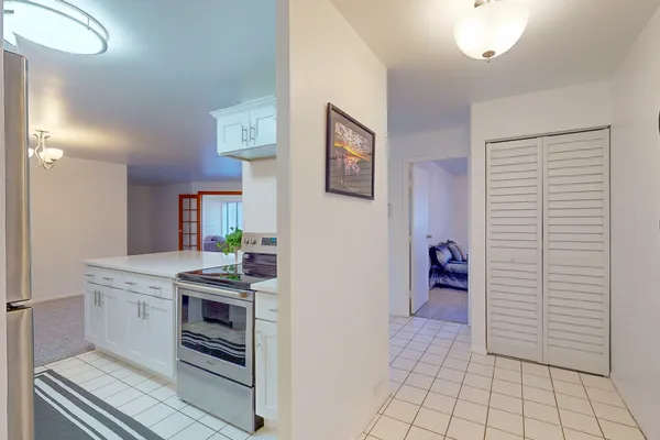 a kitchen view with furniture a stove and a refrigerator