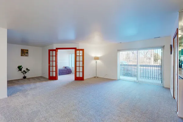 an empty room with sliding door and mountain view