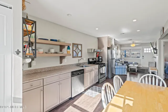 a kitchen with stainless steel appliances granite countertop a refrigerator sink and stove