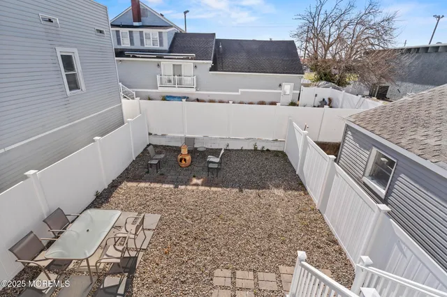 a building outdoor space with patio furniture and potted plants