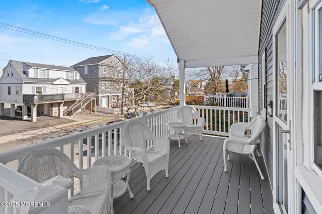 a view of a balcony with wooden chairs