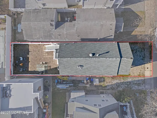 an aerial view of residential houses with yard