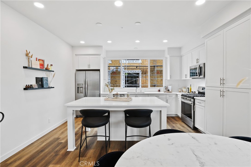 42 Bigsby Drive Stanton, CA 90680 - Photo 21 of 40 a kitchen with stainless steel appliances kitchen island granite countertop a sink and cabinets