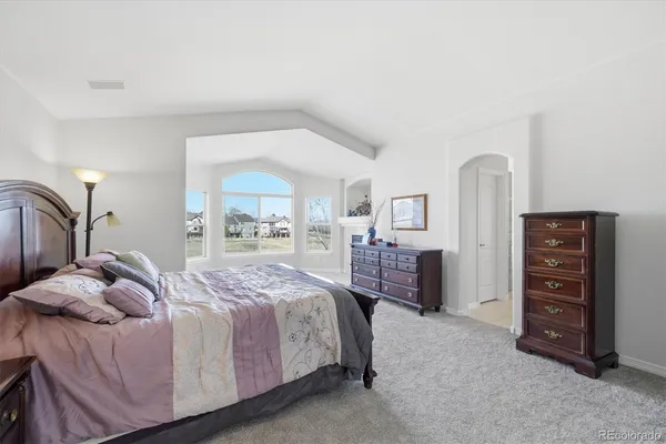 a bedroom with a bed and a dresser