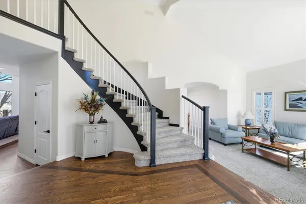 a view of a livingroom with furniture and stairs