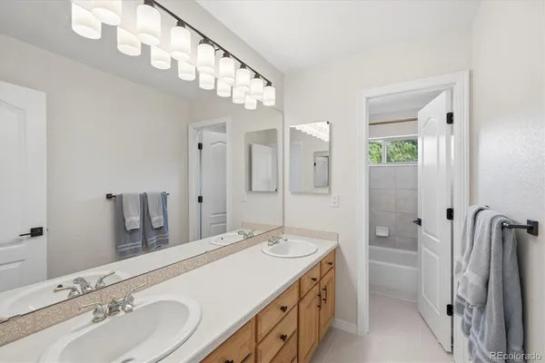 a bathroom with a double vanity sink and a mirror