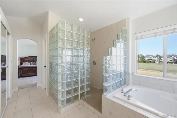 a bathroom with a bathtub and a shower