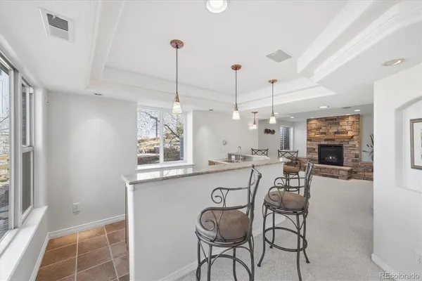 a view of a dining room and livingroom with furniture wooden floor a chandelier