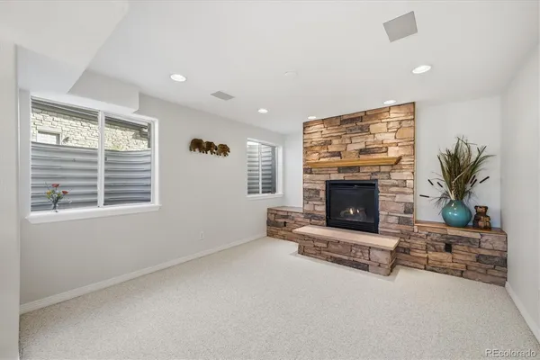 a living room with furniture a window and a fireplace