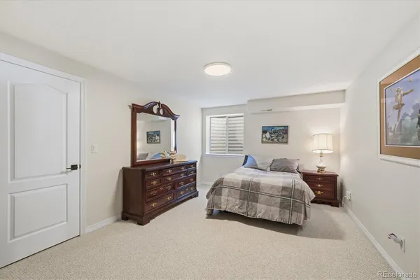 a bedroom with a bed and dresser