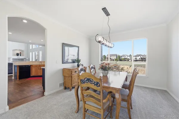 a view of a dining room with furniture and a kitchen