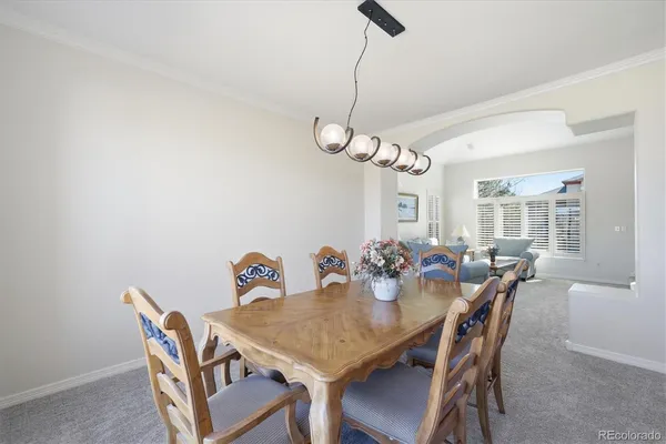 a view of a dining room a table and chairs