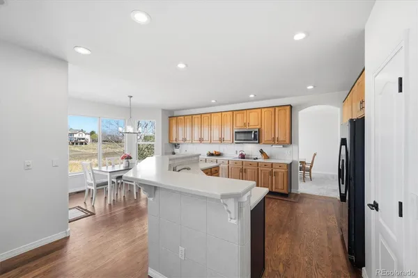 a large kitchen with a table and chairs