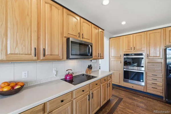 a kitchen with stainless steel appliances a stove sink microwave and cabinets