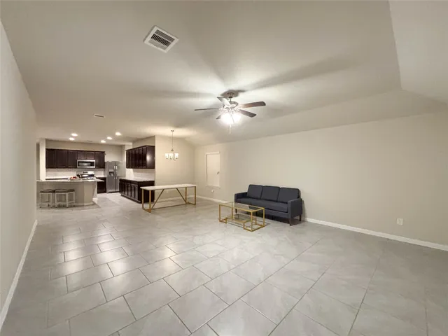 a living room with furniture and kitchen view