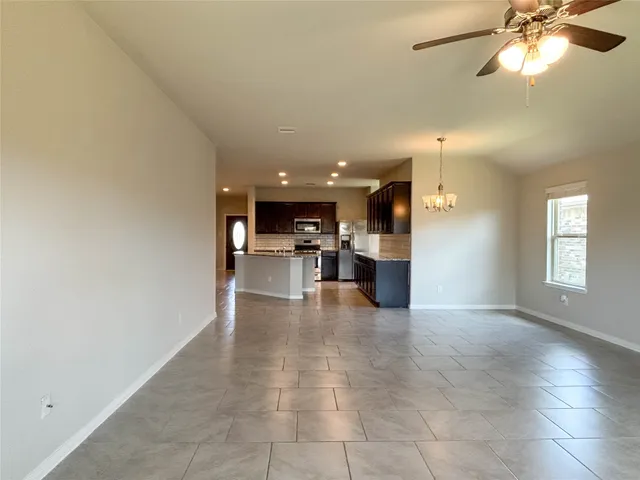 a view of a livingroom with furniture and a ceiling fan