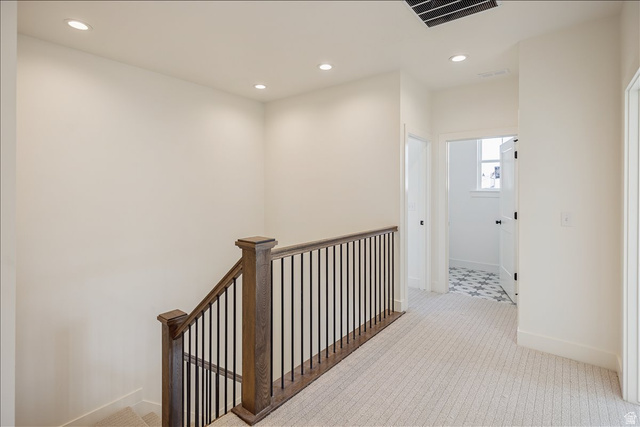 7189 South Sage Road, Unit 214 West Jordan, UT 84081 - Photo 18 of 29 Upper landing featuring a wood-finish and wrought iron baluster staircase