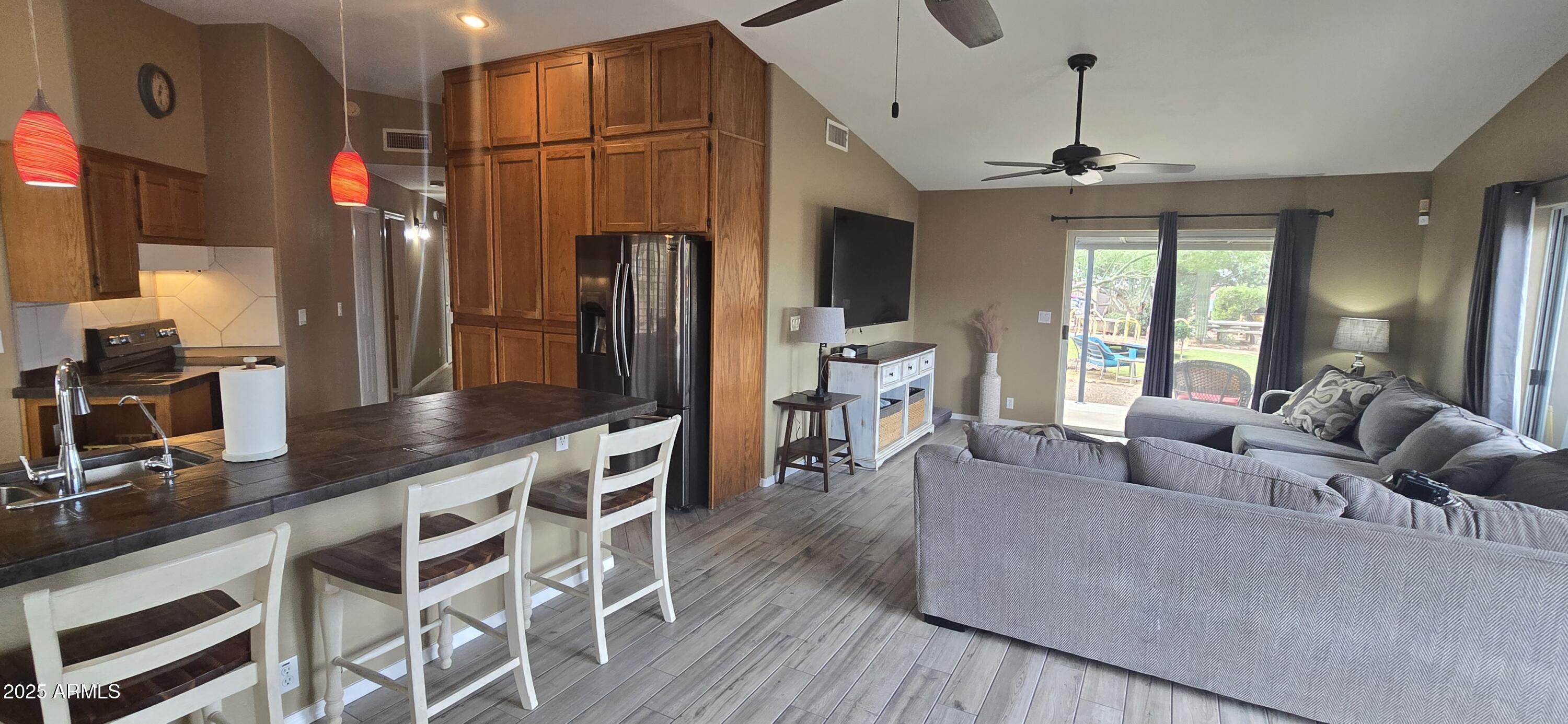 1502 South Prospectors Road Apache Junction, AZ 85119 - Photo 14 of 77 a living room with furniture a flat screen tv and a chandelier
