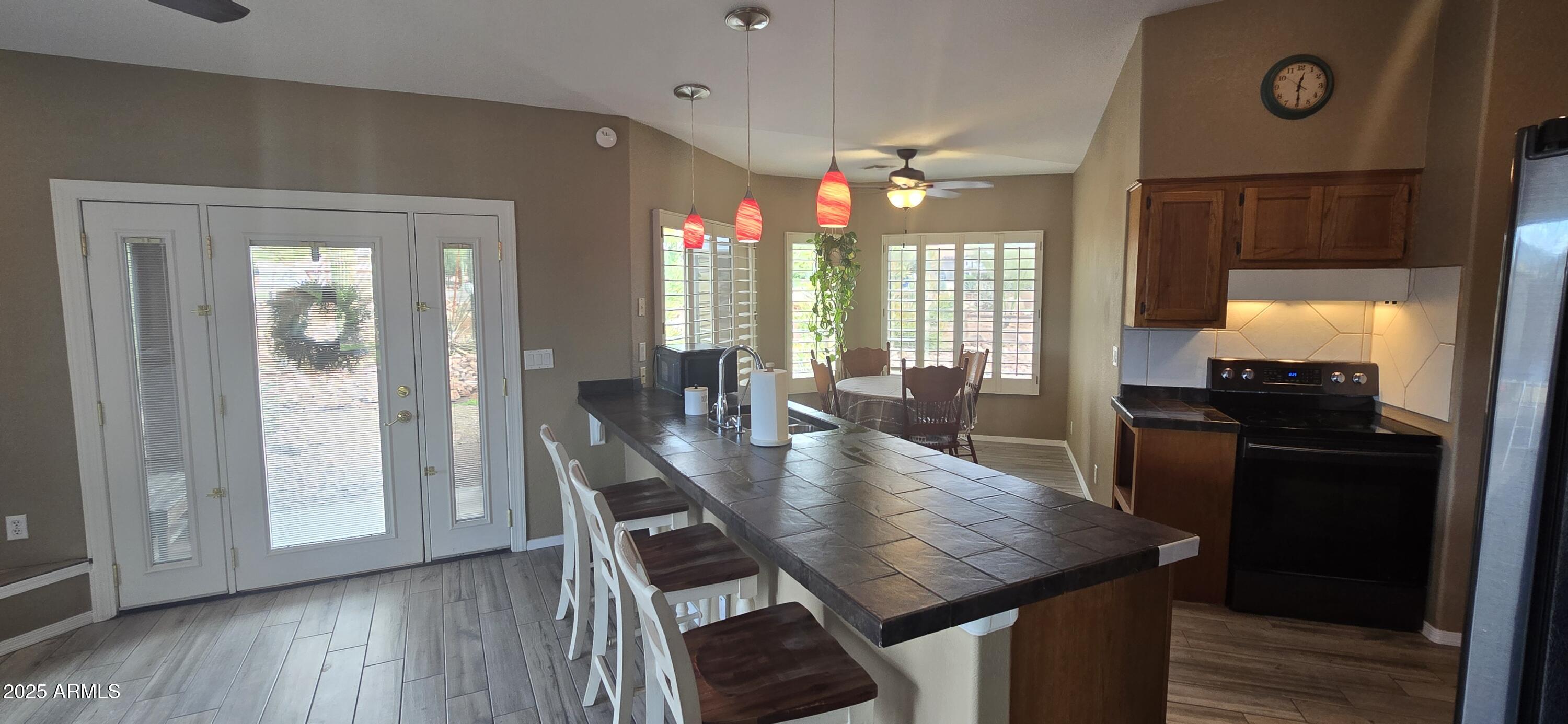 1502 South Prospectors Road Apache Junction, AZ 85119 - Photo 15 of 77 a view of a dining room with furniture window and wooden floor