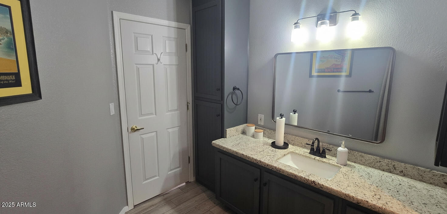 1502 South Prospectors Road Apache Junction, AZ 85119 - Photo 20 of 77 a bathroom with a granite countertop sink and a mirror
