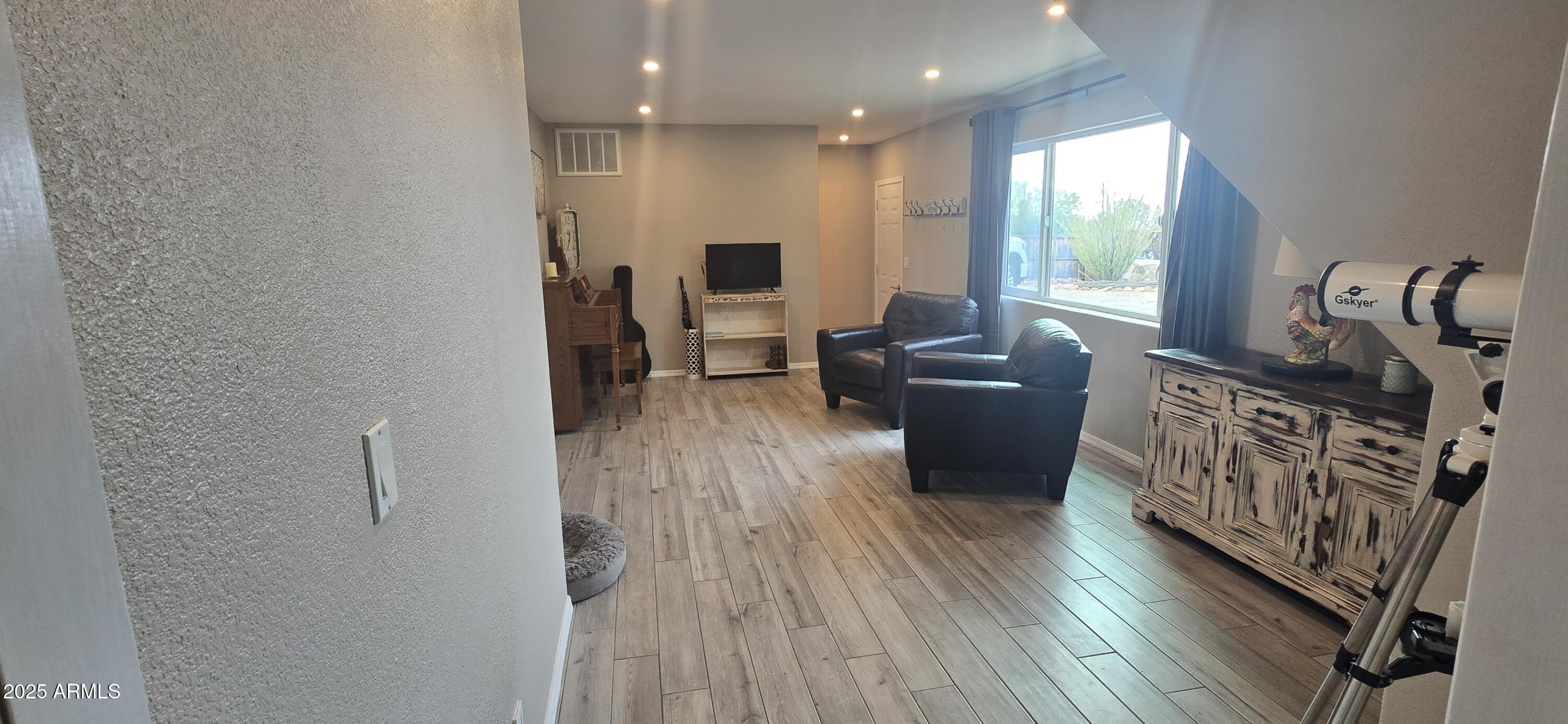1502 South Prospectors Road Apache Junction, AZ 85119 - Photo 28 of 77 a living room with furniture and wooden floor