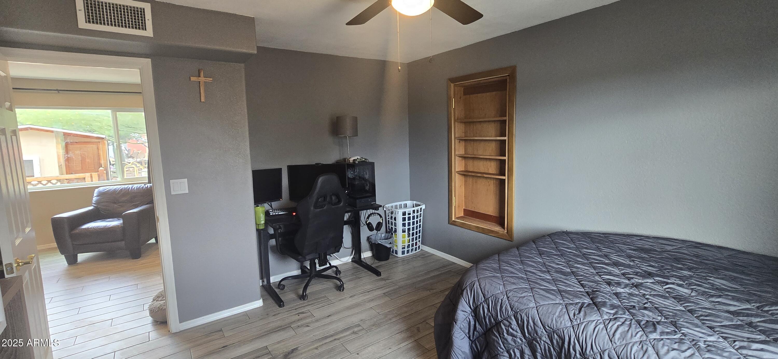 1502 South Prospectors Road Apache Junction, AZ 85119 - Photo 30 of 77 a bedroom with a bed and a chandelier