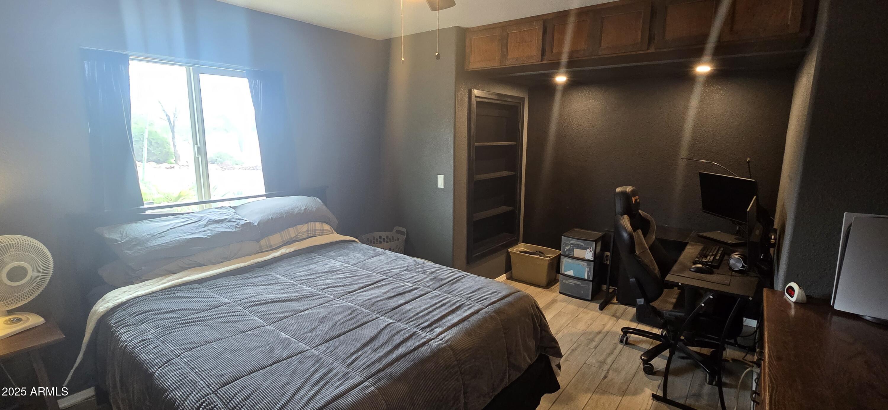 1502 South Prospectors Road Apache Junction, AZ 85119 - Photo 32 of 77 a bedroom with a bed and a large mirror in it