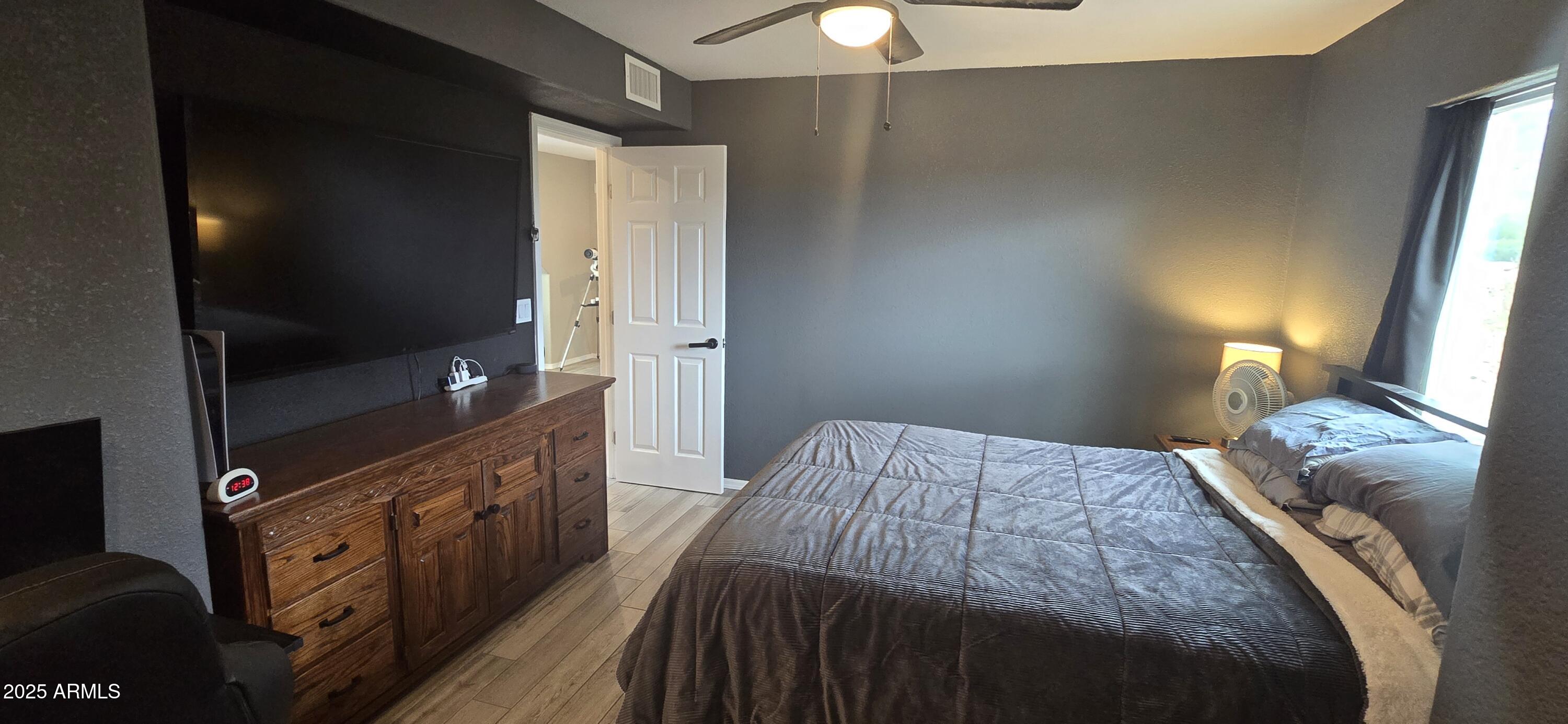 1502 South Prospectors Road Apache Junction, AZ 85119 - Photo 33 of 77 a bedroom with a bed and a flat tv screen on dresser