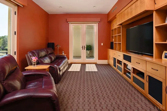 a bed sitting in a spacious bedroom next to a window