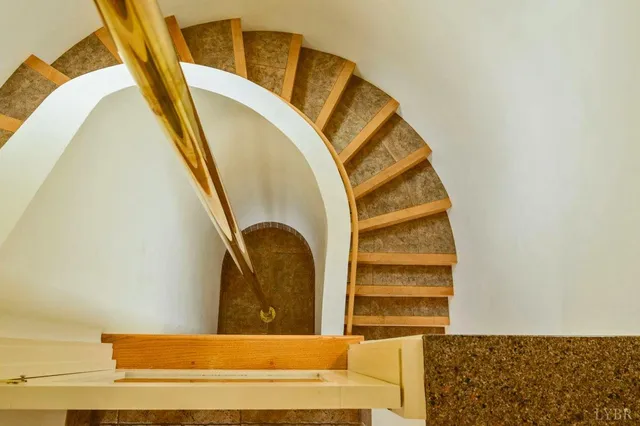 an empty room with a large window and mirror