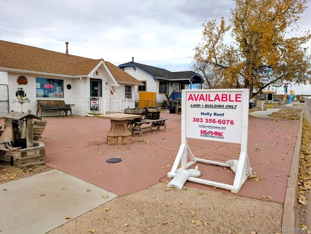 a view of a white house with swimming pool