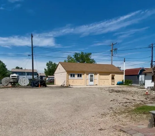 a wooden bench sitting in front of a house