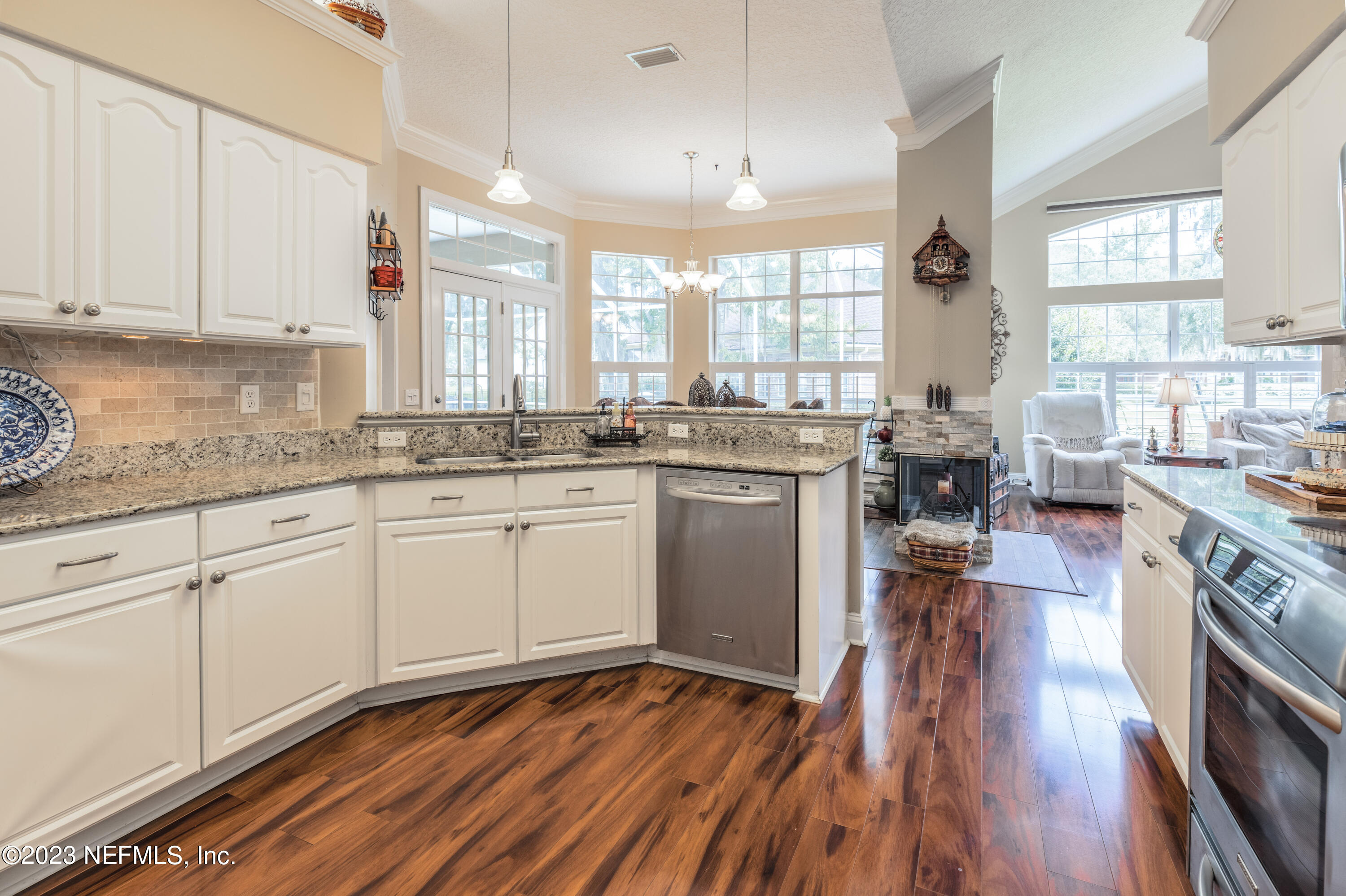 729 Cherry Grove Road Orange Park, FL 32073 - Photo 13 of 47 a kitchen with stainless steel appliances granite countertop wooden floors sink stove and cabinets