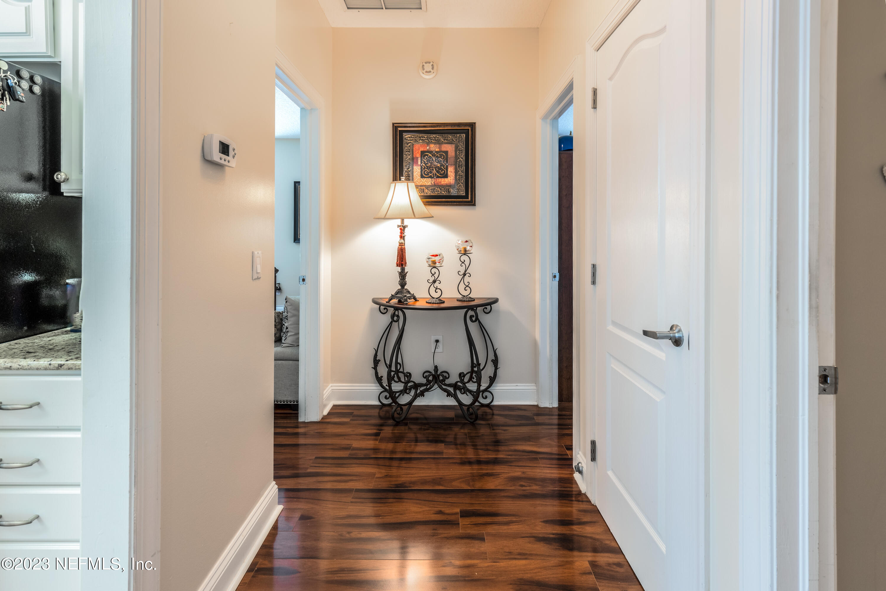 729 Cherry Grove Road Orange Park, FL 32073 - Photo 22 of 47 a view of a hallway with wooden floor and a bathroom
